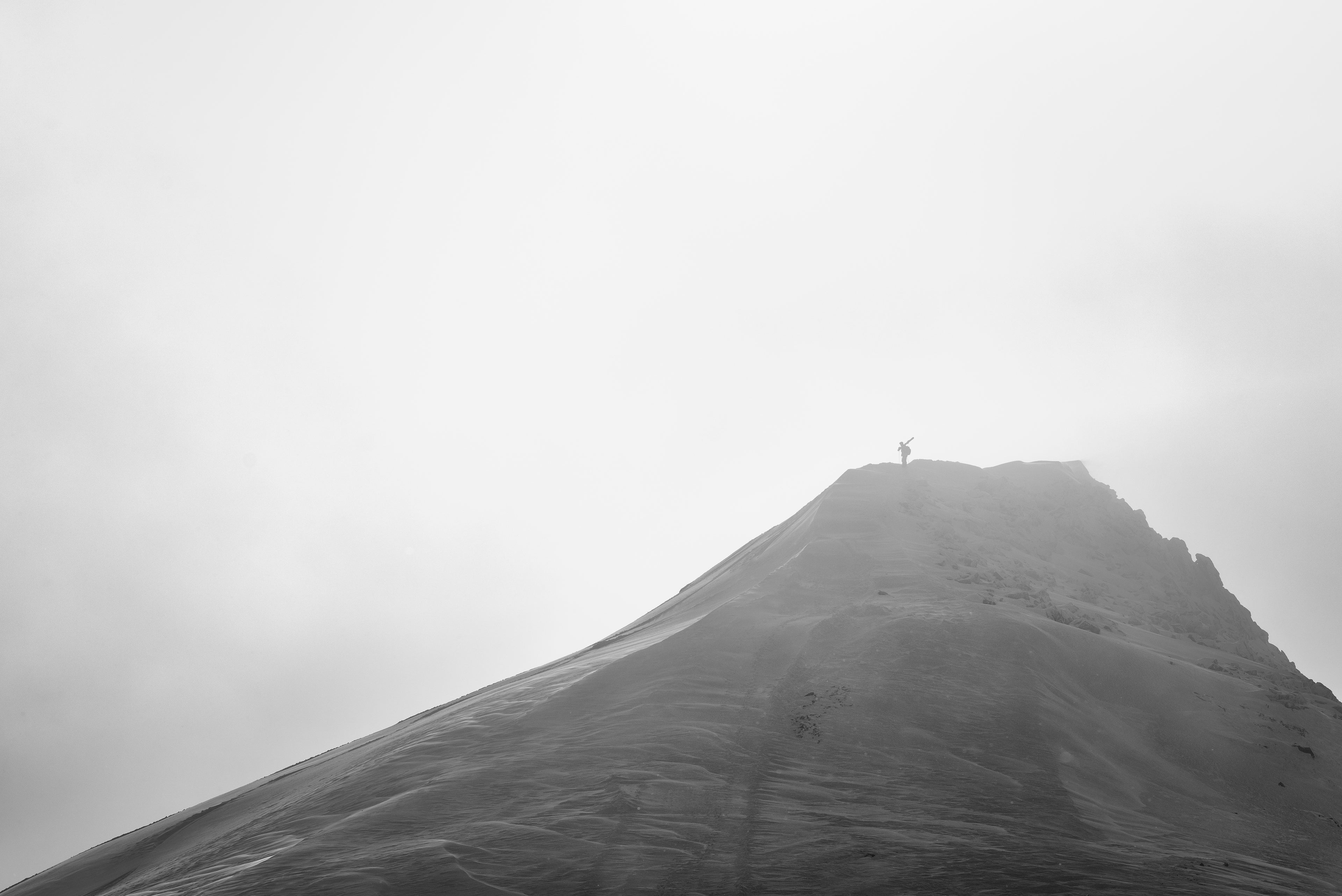 Skier standing at the top of a snow covered moutain